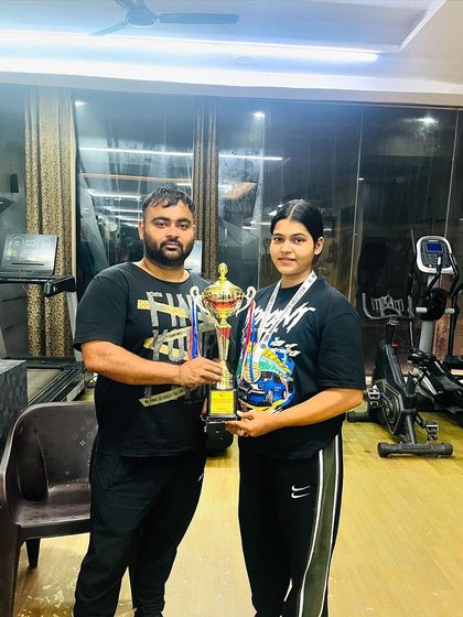 My junior lifter Yashika with her trophy after winning a gold medal and the strongwoman title at an inter-university competition. A proud moment for our team.