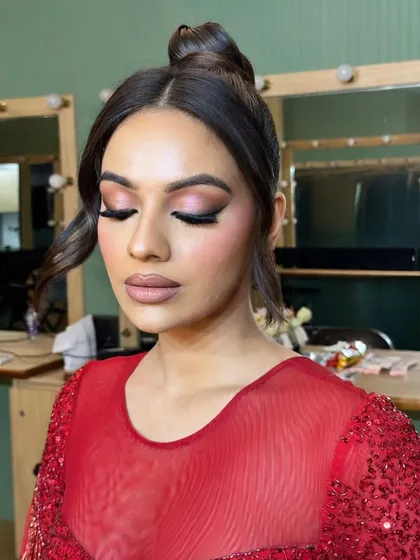 The eyes are closed to show the seamless blend of the soft, shimmery eyeshadow in this unfiltered cocktail makeup look.