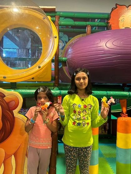 Two girls enjoying a snack in our play area. Celebrating a decade of fun means celebrating all the friendships and happy moments shared within our walls.