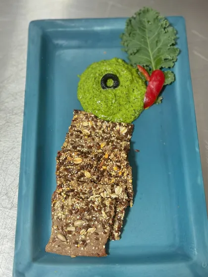 First up on our bread series: flatbread crackers made with multiple seeds and grains, served with a vibrant green dip made from our own farm-fresh herbs.
