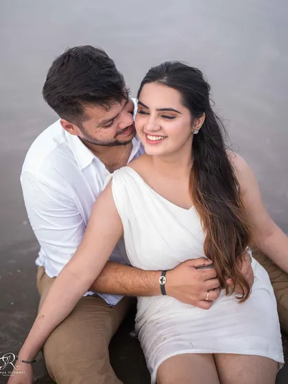A sweet and intimate moment during their beach session. The way he whispers to her and her gentle smile makes this a truly romantic and candid photograph.
