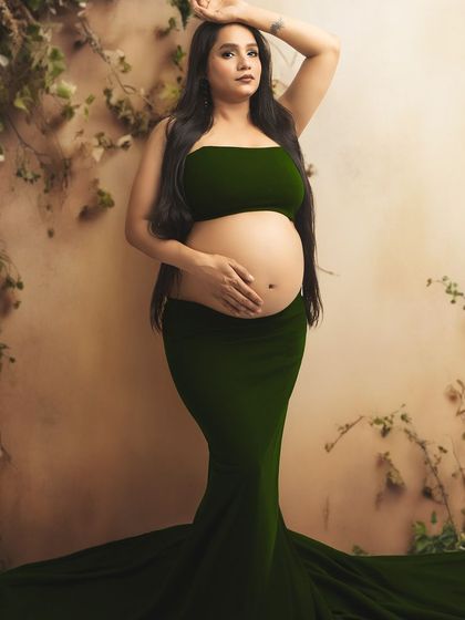 A confident and beautiful pose in a two-piece gown that tastefully showcases the baby bump.