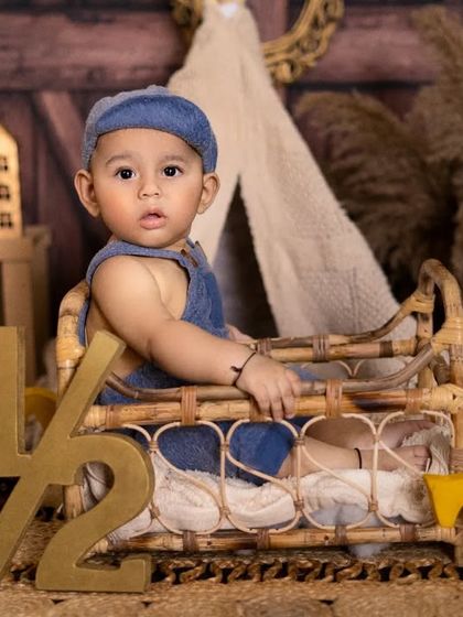 Halfway to one and looking so grown up. This little boy's portrait in a rustic, bohemian setting is a perfect way to mark his six-month milestone.