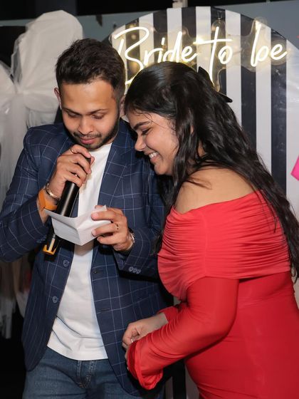 More game-time fun, with the bride-to-be and her friends sharing a laugh.