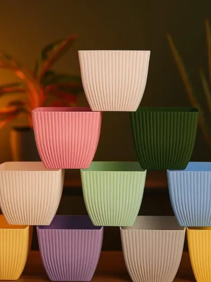 I offer a wide range of decorative pots to go with my artificial plants. This image shows a collection of square, ribbed pots available in many different colors to match any interior style.