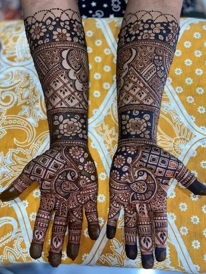 This design features large, beautiful peacocks on the palms, with the arms covered in a mix of floral and geometric patterns.