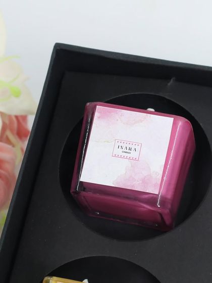 A vibrant pink candle, part of a curated gift set. We love creating colorful and fragrant combinations for our clients.