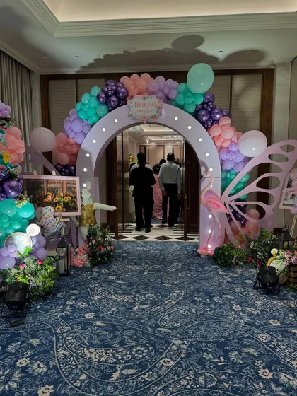 The entrance to the ONEderland party was a beautiful archway decorated with pastel balloons and flanked by large butterfly wing props.