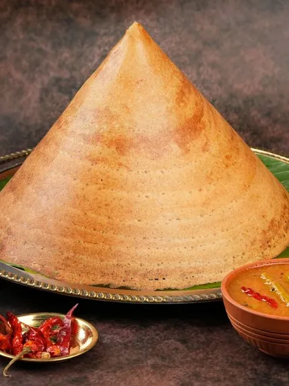 Capturing the impressive scale and perfect texture of this cone dosa was a fantastic challenge. We style traditional dishes to look authentic yet premium for high-end restaurant menus and delivery apps.