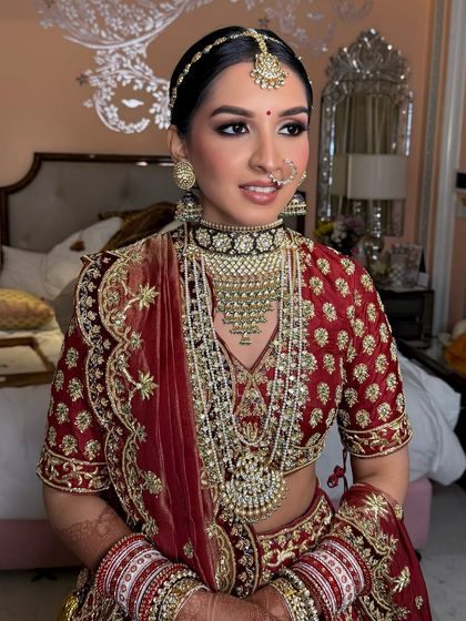 The complete bridal look, featuring a sleek bun with traditional jewelry, perfect for a grand wedding ceremony.