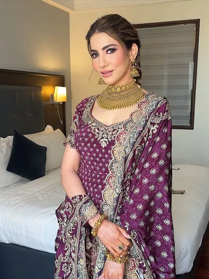 The full look. The rich color of her outfit is beautifully complemented by the warm tones in her makeup.