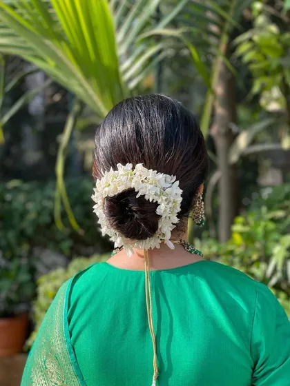 The back view of the classic gajra bun. It's a timeless and elegant hairstyle that beautifully complements a traditional silk saree.