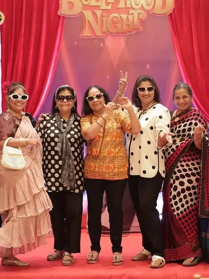 Getting into character! Guests fully embraced the retro theme, posing for a group photo on the red carpet. A strong theme encourages participation and makes for fantastic photos and memories.