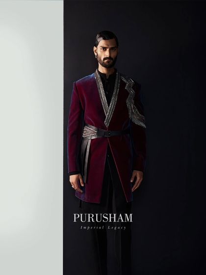 Designs that transpire the test of time. This wine-colored velvet jacket, with its asymmetrical silver embroidery and leather belt, welcomes you into a world of modern royalty.