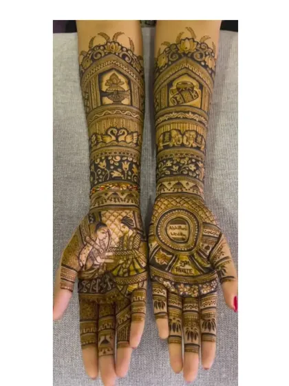 Here is a full-arm bridal design with detailed portraits. One hand shows the bride, while the other features the groom, with wedding ceremony elements decorating the arms.