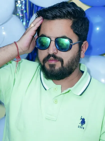 A casual and cool portrait of a man in sunglasses at a party. This type of event photography captures the vibe and personality of guests in a relaxed, informal setting.