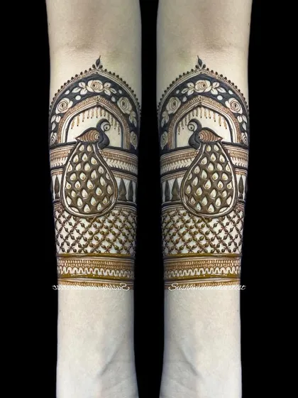 A clean and bold peacock design for the forearm. Notice the contrast between the dark filled areas and the delicate net pattern. This is a great example of a modern traditional motif.