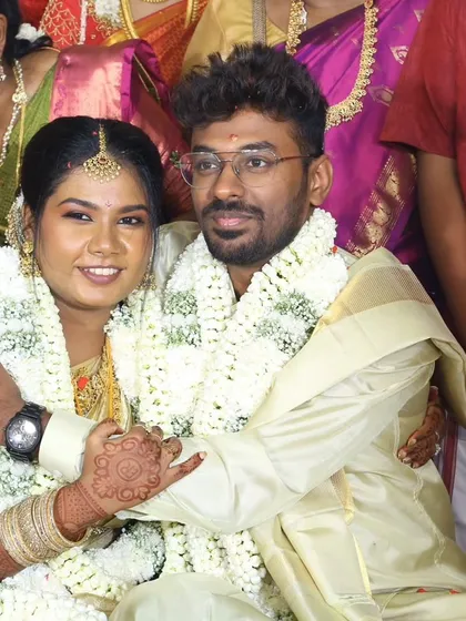 A happy couple during their muhurtham ceremony. The bride's makeup is natural and glowing, perfect for capturing these precious memories.