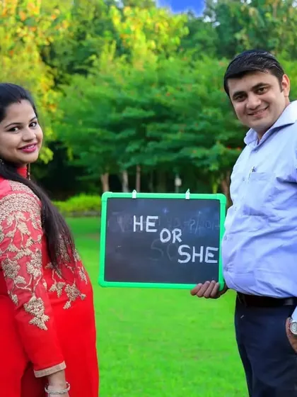 We love getting creative with props during our maternity shoots. A "He or She" chalkboard adds a fun element of surprise to this couple's pregnancy announcement photos.
