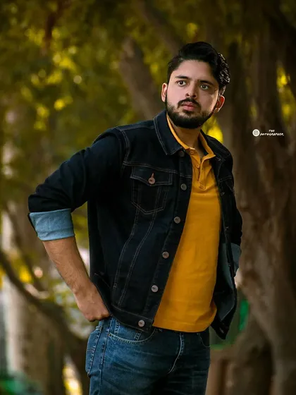 A classic men's portrait taken outdoors. The focus here is on a natural, confident look, using the soft light and background to make the subject stand out.
