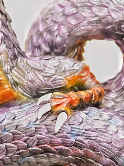 Close-up of the dragon's claws, meticulously sculpted and painted. Every detail, down to the talons, is crafted for maximum impact.