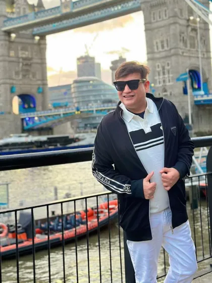 A dynamic pose by the Thames, showing off my Prada jacket against the backdrop of London's architecture.