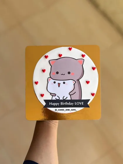 A sweet "Happy Birthday Love" cake with an adorable cat couple illustration.