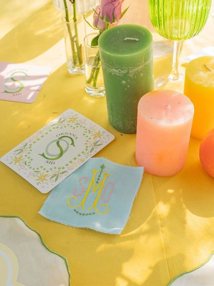 A close-up of the custom stationery and colorful candles that added a personal and vibrant touch to the tables.