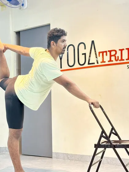 Another angle of using the chair for Natarajasana. This prop makes the pose more accessible and helps in building the strength and flexibility required for the full expression.