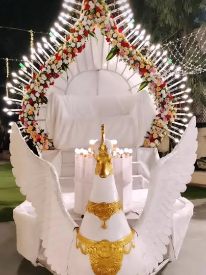 For a truly unique bride and groom entry, I designed this magnificent winged peacock chariot. This custom structure, complete with intricate lighting and floral details, ensures your arrival is a spectacular and memorable part of the celebration.