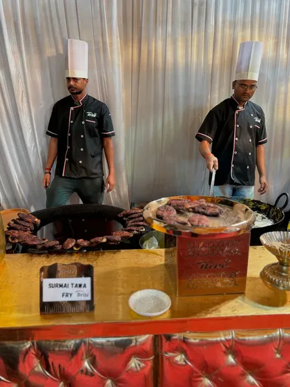 My chefs at the Surmai Tawa Fry counter, set up with a large tawa for live cooking, ensuring every piece is hot and fresh.