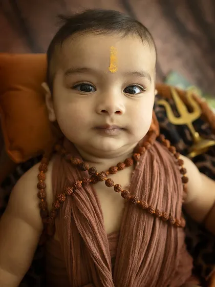 A serene and powerful close-up, focusing on the baby's calm gaze.