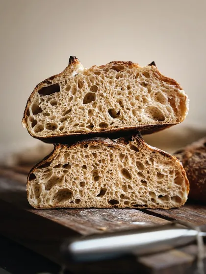 Capturing the perfect texture of bread is an art. This cross-section of a sourdough loaf, with its beautiful open crumb structure, was shot to highlight the baker's skill and the rustic quality of artisanal baking.