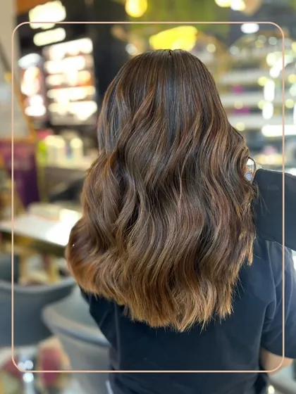 A perfect example of our custom-blended brunette balayage. We used a freehand painting technique to create these seamless, sun-kissed ribbons of colour, styled with loose waves for a natural, lived-in feel.