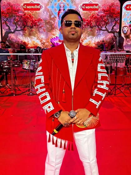 Standing in front of the grand Navratri stage backdrop. The visual setup of an event is just as important as the performance itself.
