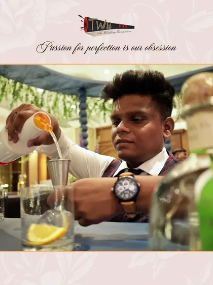 A close-up of a bartender pouring a vibrant orange cocktail, highlighting the fresh ingredients and careful technique.