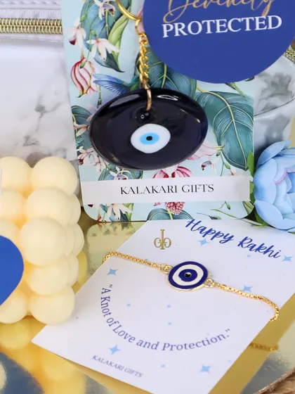Our "Divinely Protected" evil eye Rakhi gift hamper. This set includes an evil eye Rakhi, a matching keychain, and a bubble candle.