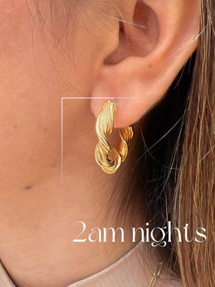 A closer look at our twisted gold hoops, perfect for late nights out. Their unique texture catches the light beautifully, making them a chic and modern accessory.