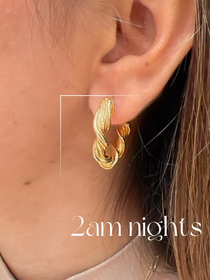 A closer look at our twisted gold hoops, perfect for late nights out. Their unique texture catches the light beautifully, making them a chic and modern accessory.