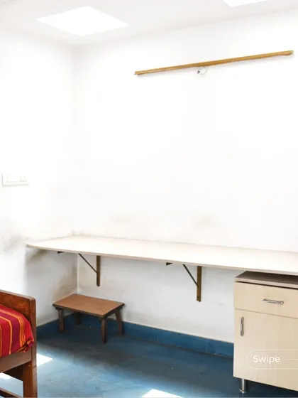 A simple and functional study or bedroom space, with a floating desk and a bed. The skylight provides ample natural light for working or reading.