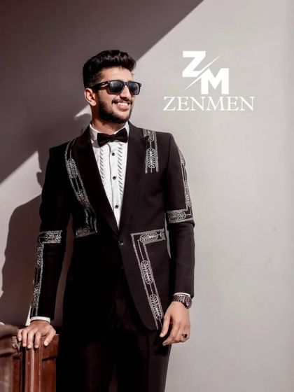The same model in the black and silver geometric tuxedo, captured in a moment of candid style. The sunlight highlights the shimmering beadwork.