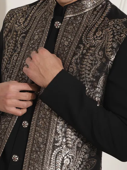 The buttons and embroidery detail on this black and silver Indo-Western jacket are chosen to complement the design and add a touch of luxury.