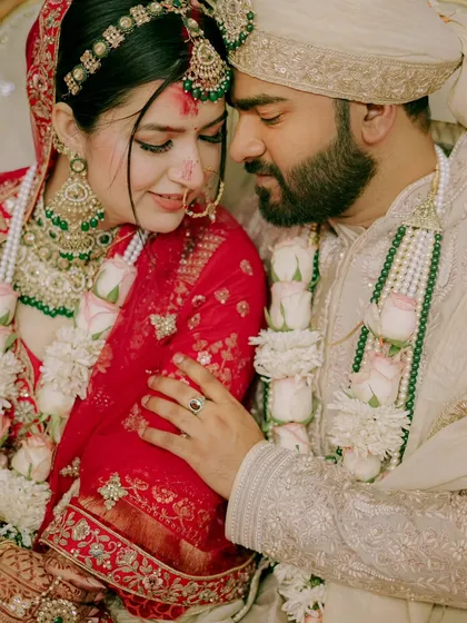 A close up, emotional moment between the bride and groom after the Varmala ceremony. This frame is filled with love, tradition, and the beautiful colors of their wedding attire.