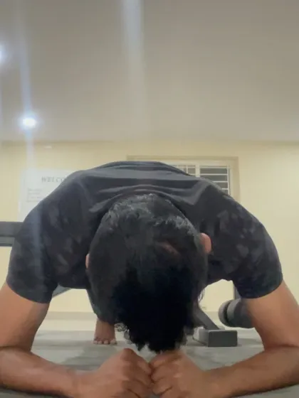 The lowest point of a fist pushup, maintaining a straight line from head to heels. This builds resilience in the hands and forearms.