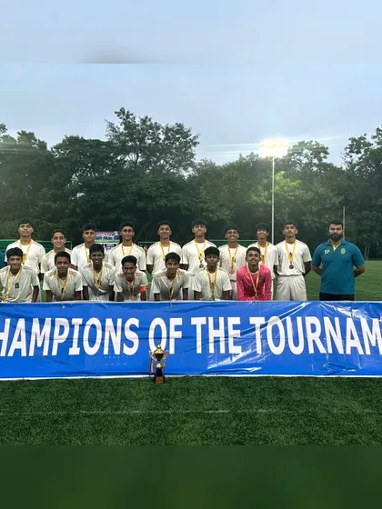The team celebrating with their "Champions of the Tournament" banner after winning the CISCE U-19 regionals.