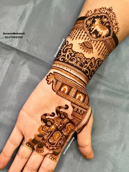A partial view of the design, showing the intricate work on the elephant and the start of the architectural patterns on the palm.