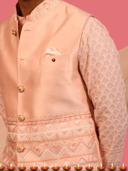Here you can see the fine detailing on a peach Nehru jacket set. The geometric embroidery on the jacket hem complements the delicate chikankari work on the kurta sleeve, showing how I layer textures for a cohesive look.