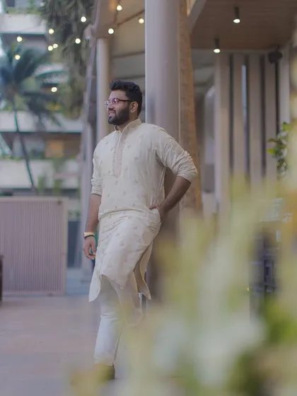A relaxed and stylish portrait of the groom in a simple kurta, taken during one of the pre-wedding events.