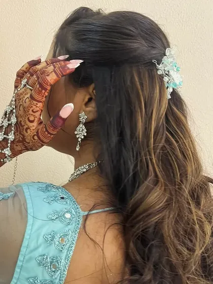 A close up of the beautiful henna stain, paired with gorgeous hair and jewelry. It's all about the complete look.