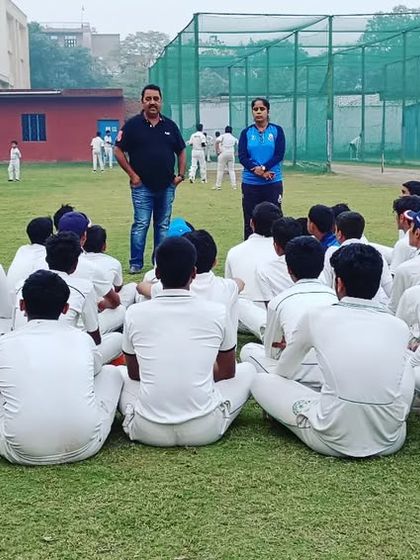 A view from behind as the junior squad listens intently during a coaching session. Discipline and respect are taught from a young age.